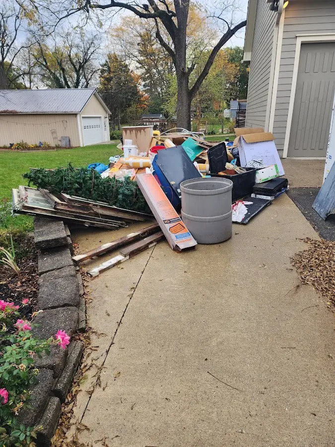 Dumpster being loaded with debris for Estate Cleanout Dumpster Rental in Pendleton